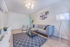 A clean and tidy room with a grey couch