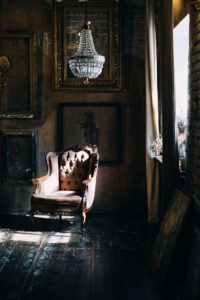 an old love seat in an old dusty room