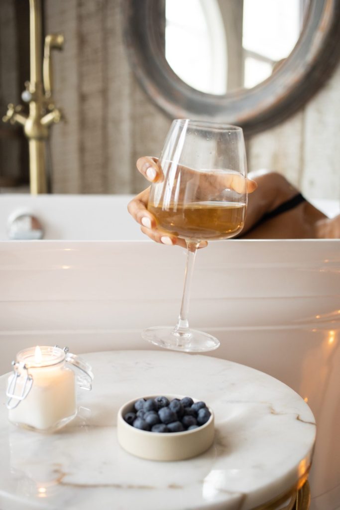 Woman In Bath Tub Sipping Wine