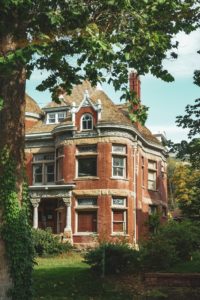 Traditional home made of brick, with a green garden