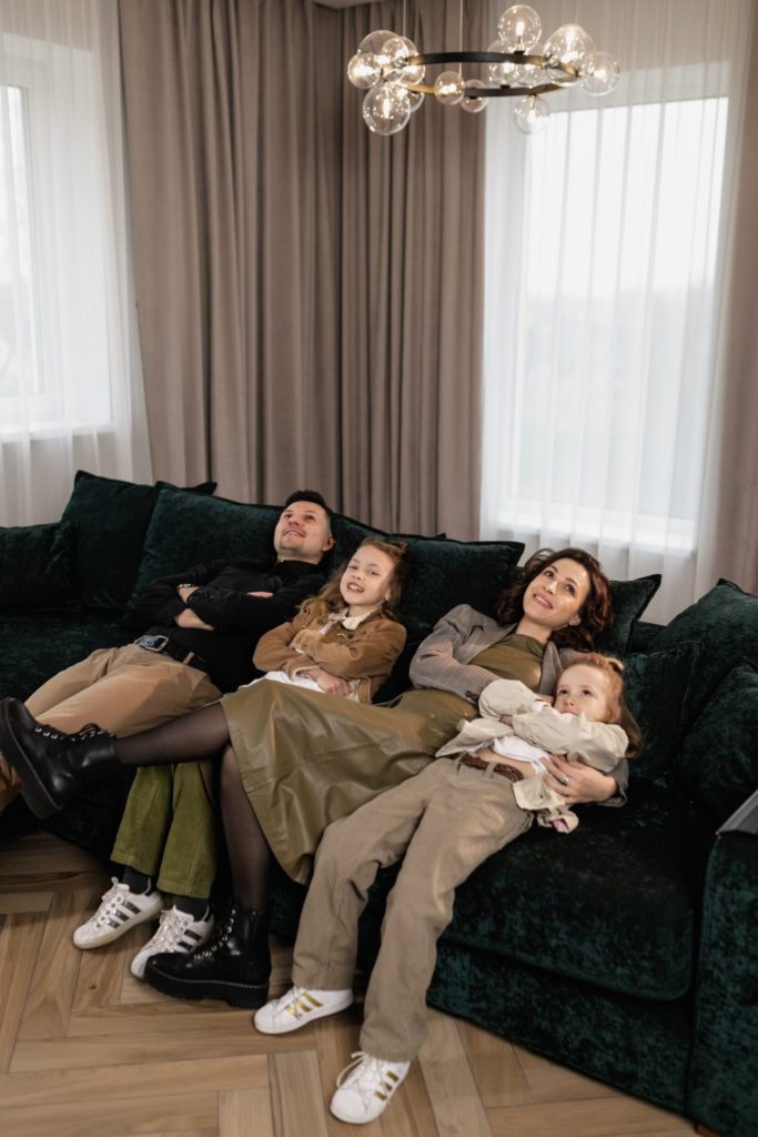 a family cuddled on a couch