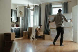 a young couple arranging furniture