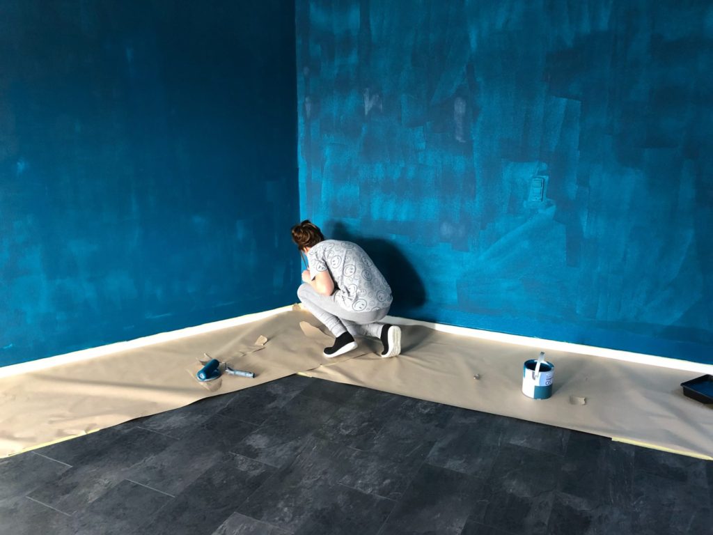 Woman Painting A Blue Room